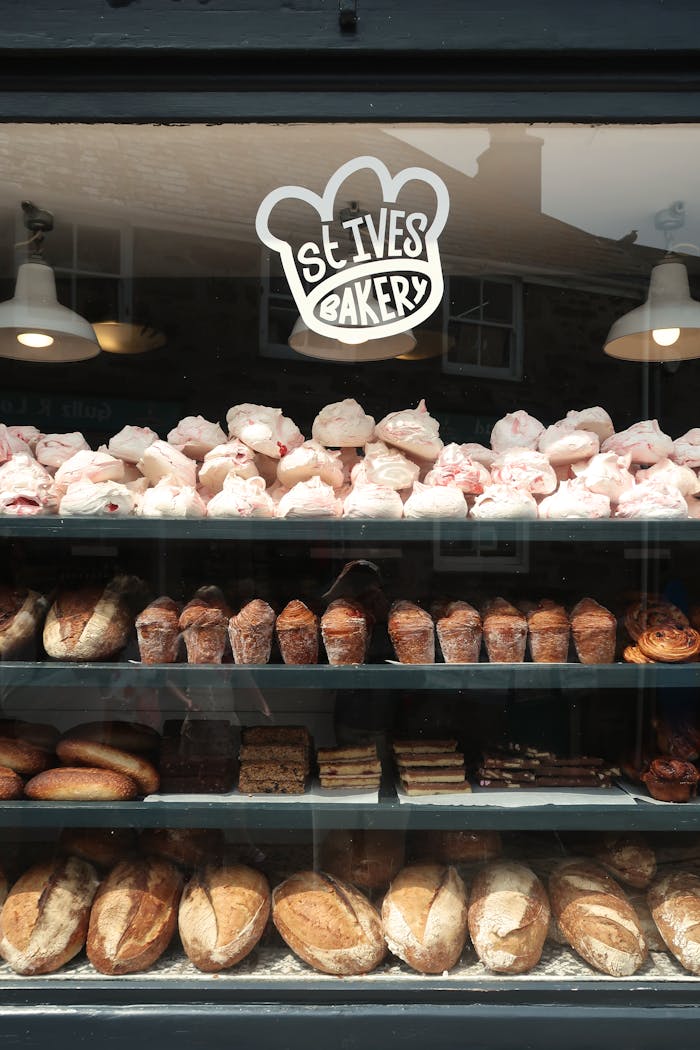 Explore the delightful display of baked goods at St Ives Bakery with fresh loaves and pastries.